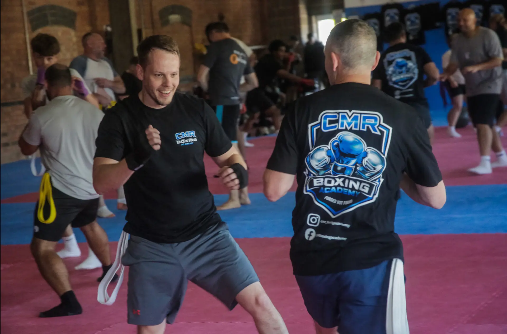 Smiling member doing partner drills at CMR