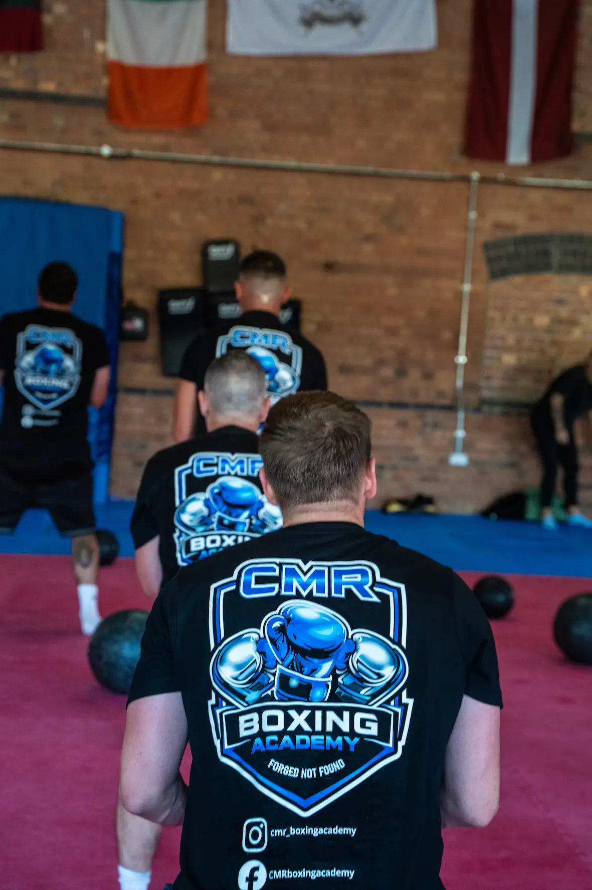 Members in CMR Boxing Academy shirts lined up for conditioning